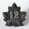 12th BN. C.E.F. Dark oxidised white metal Cap Badge original
